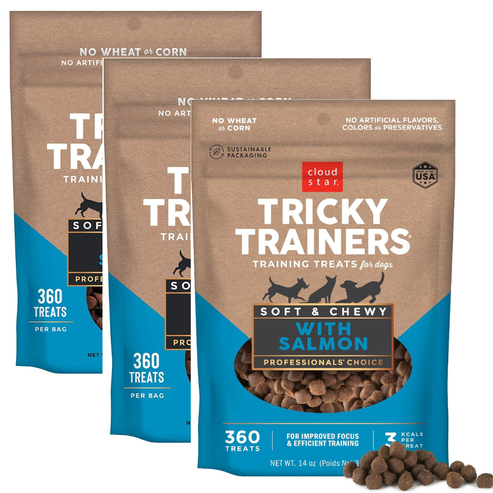 Three packages of Tricky Trainers training treats for dogs with salmon flavor on a white background.