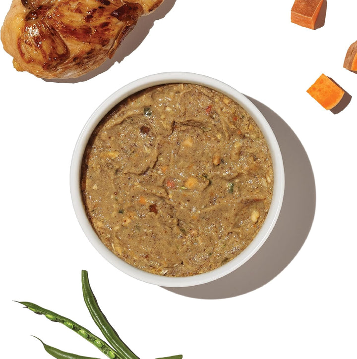 Bowl of pet food with a roasted chicken. The Honest Kitchen Grain-Free Chicken Recipe Dehydrated Dog Food