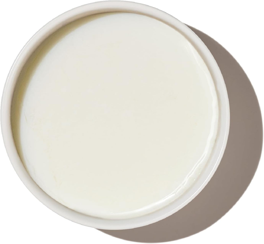 White cream in a round container on a white background. The Honest Kitchen Instant Goat's Milk with Probiotics