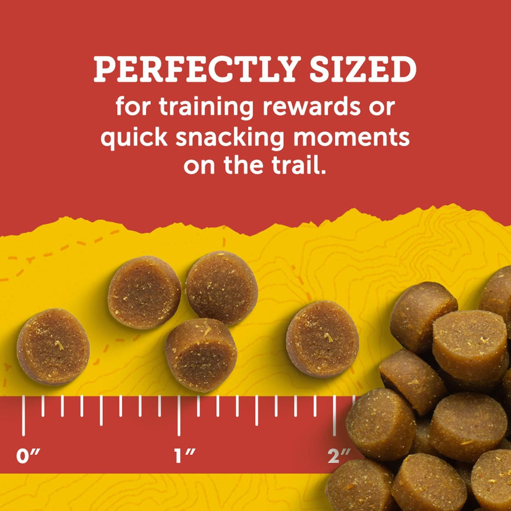 Dog treats on a yellow mat with a ruler for size reference against a red background. Zuke's Mini Naturals Dog Treats Peanut Butter